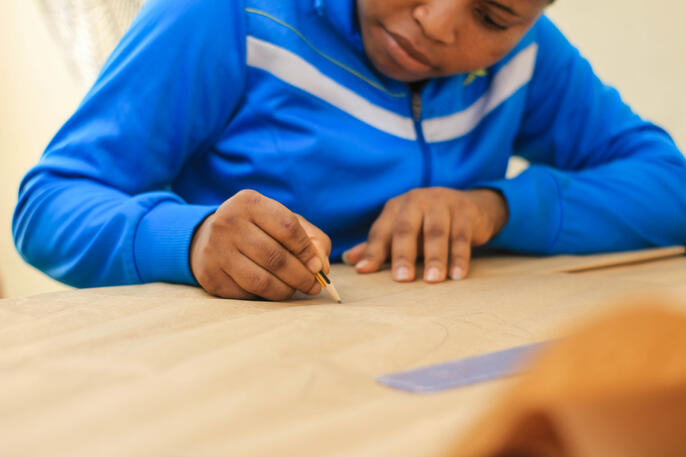 Girl drafting paper patterns