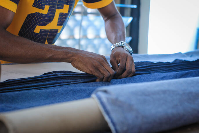 Guy cutting fabric