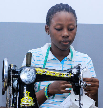 Girl sewing on machine